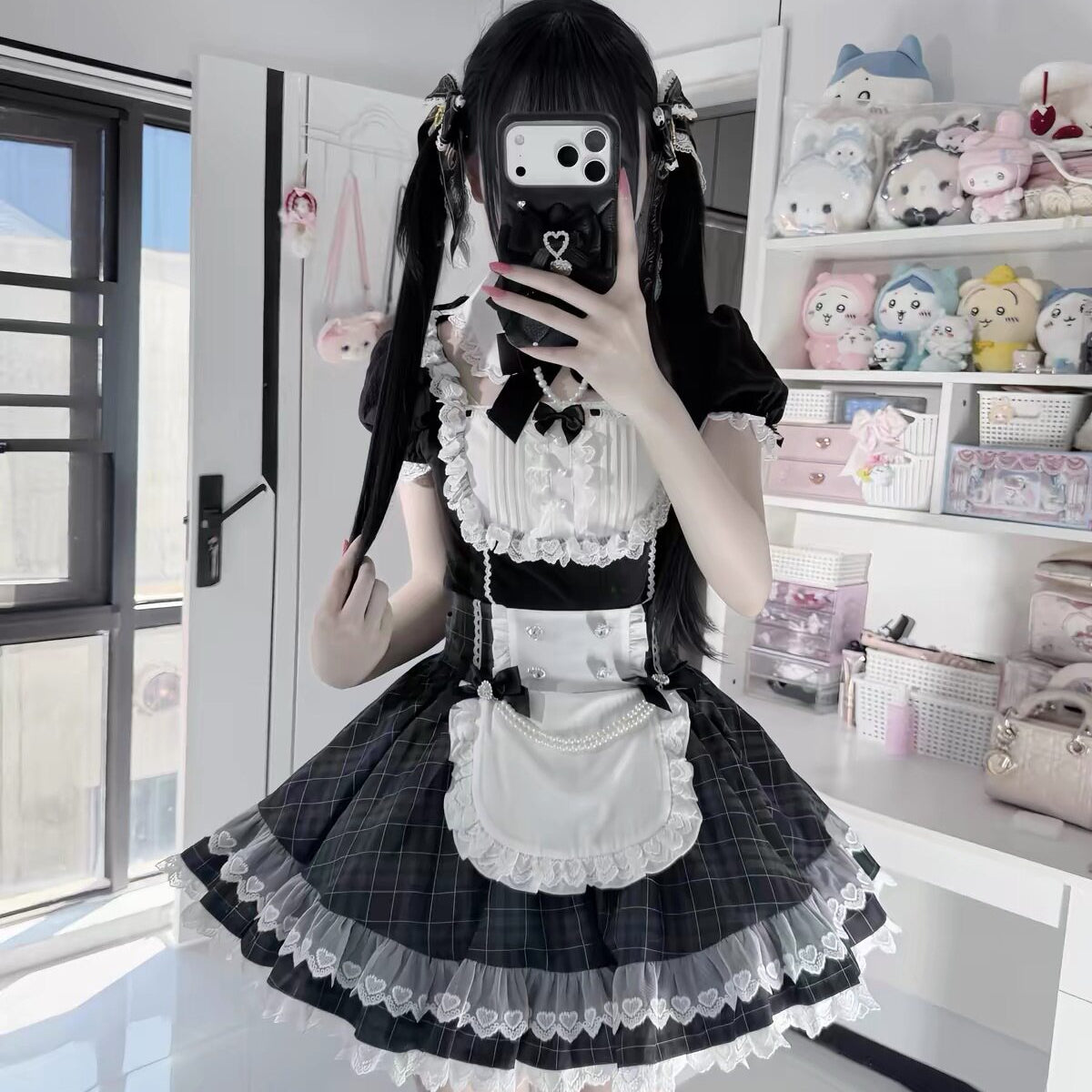 Front mirror view of the black and white Lolita dress, showing its lace bodice, white apron, and flared checked skirt.