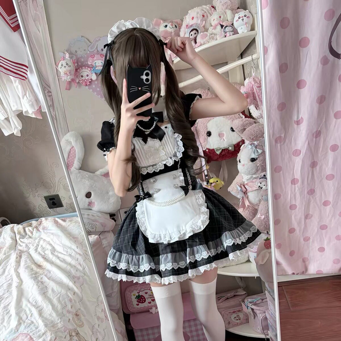 Full-length mirror view of the black and white Lolita dress, styled with white stockings and black shoes.